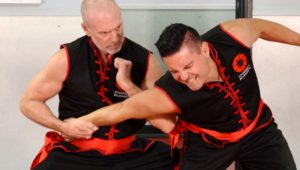 Image of Master Fisher, Founder of Combat Kung-Fu, performing an elbow dislocating technique, one of Choy Li Fut Kung-Fu's very effective close-in fighting moves.